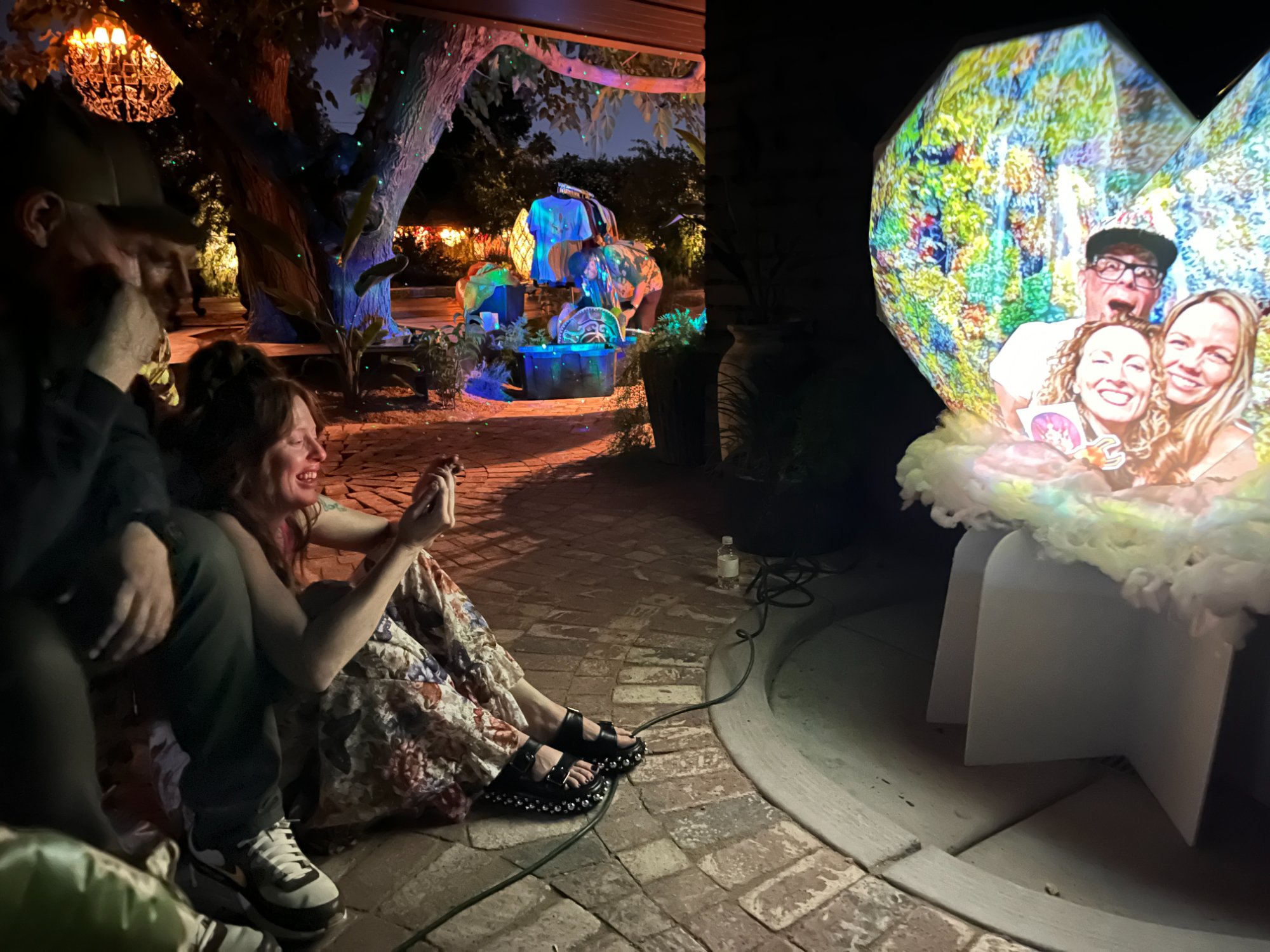 Guest smiling and photographing her tribute on the FIOH heart at a celebration of life