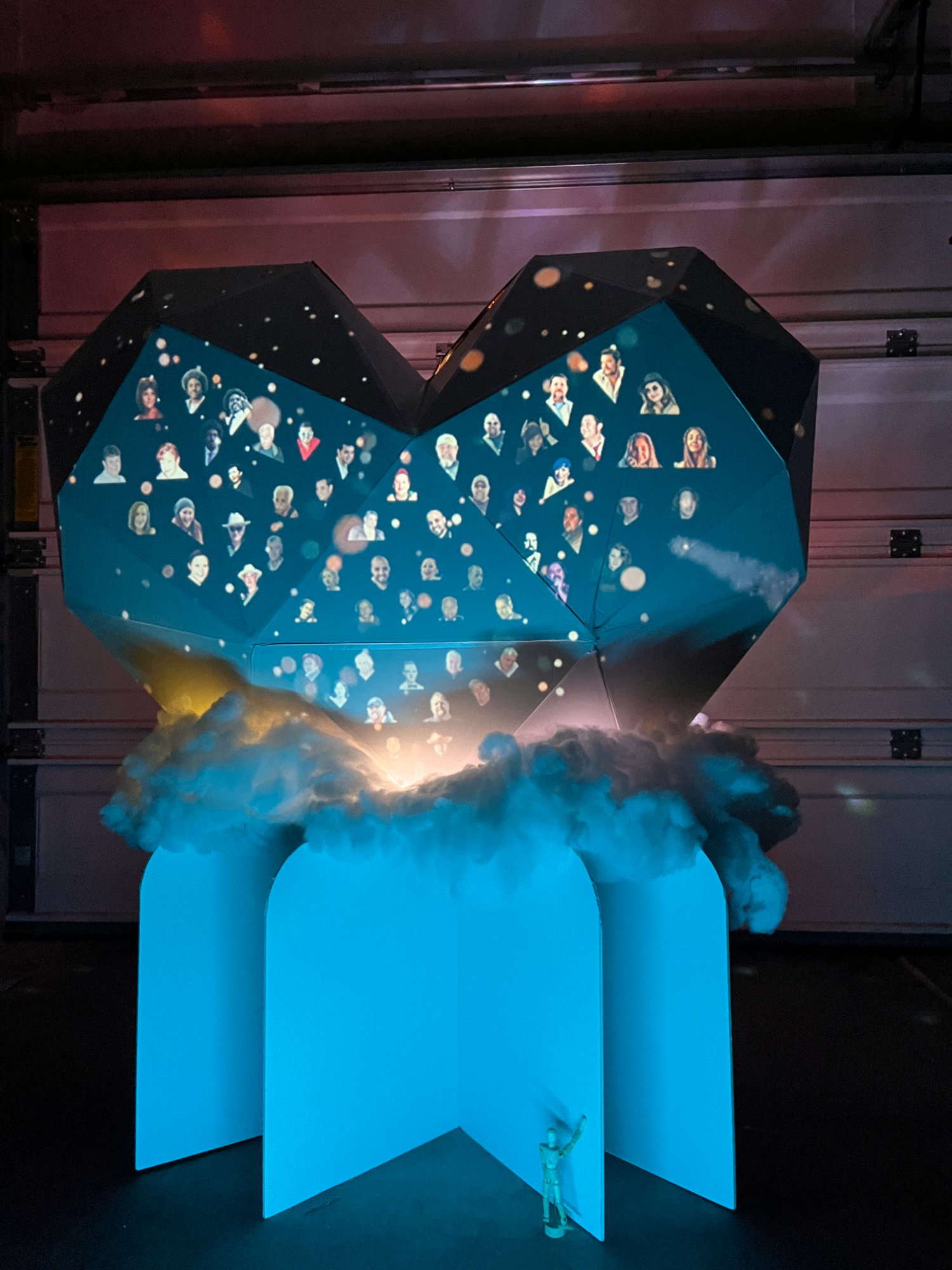 FIOH full installation with teal-lit base and grid of memorial portraits