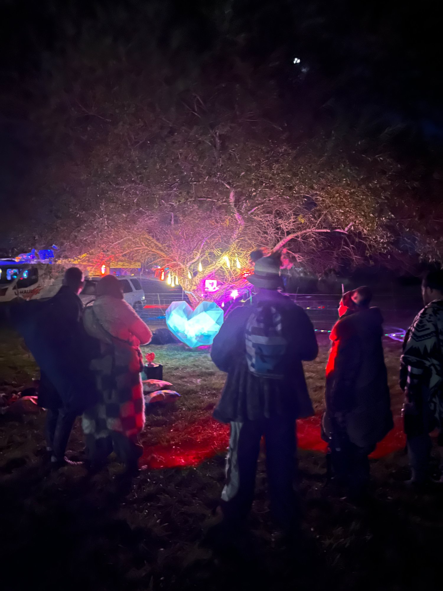 Visitors gathering around FIOH at SNRG festival at night